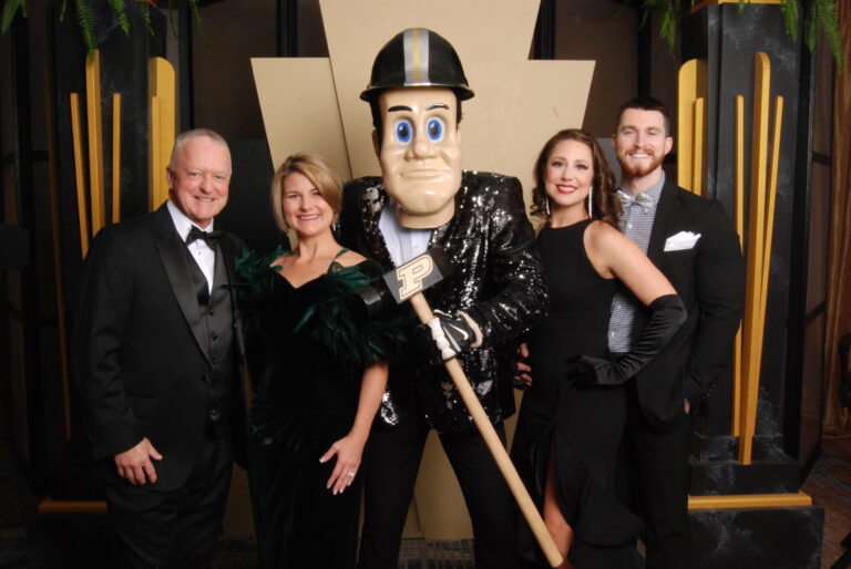 A group of people posing with Purdue Pete