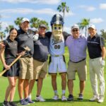 Purdue Alumni posing for photo with Purdue Pete.