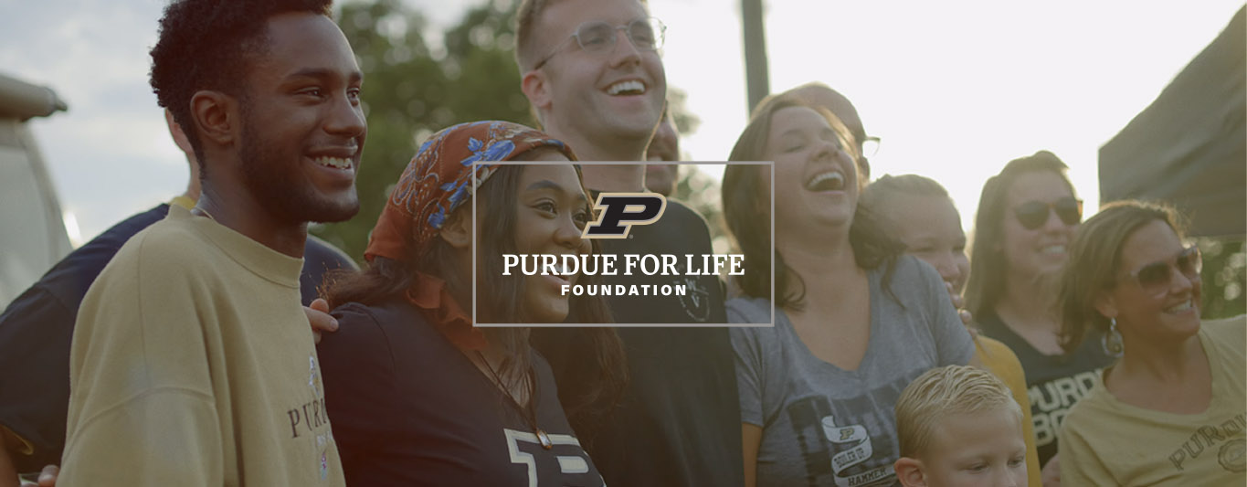 An image of people laughing with Purdue logo at screen