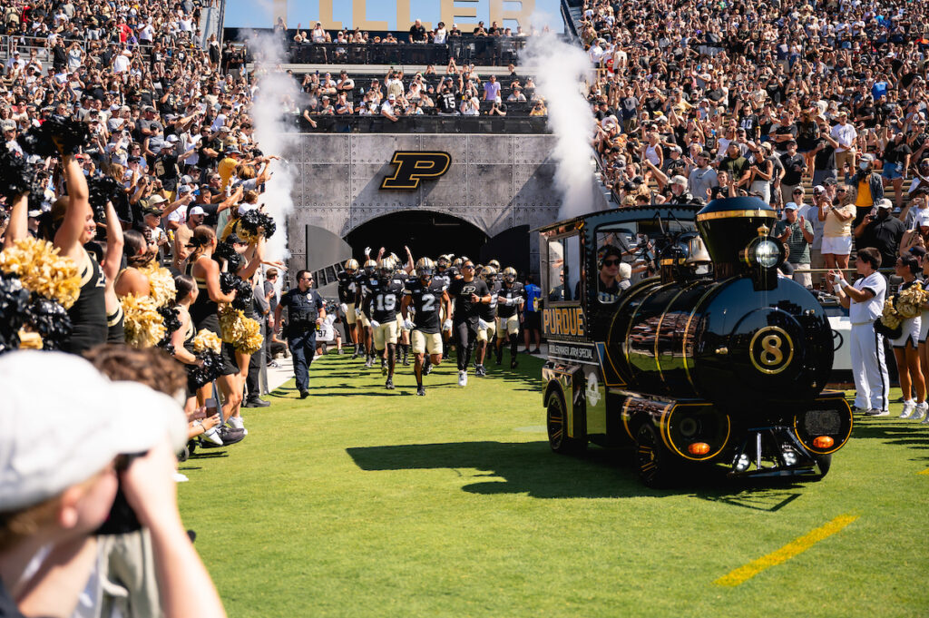Purdue's Boilermaker Extra Special leading Purdue's football team out of Tiller Tunnel