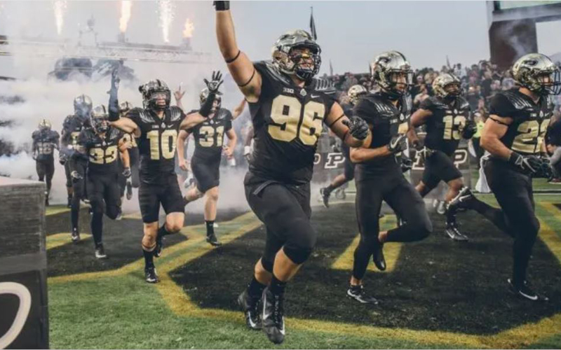 Purdue's football team running onto the field for a Purdue football game