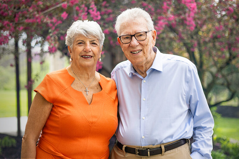 Pat and her husband Rafik Bishara standing together with their arms around one another