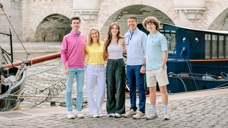 Family posing in front of a river