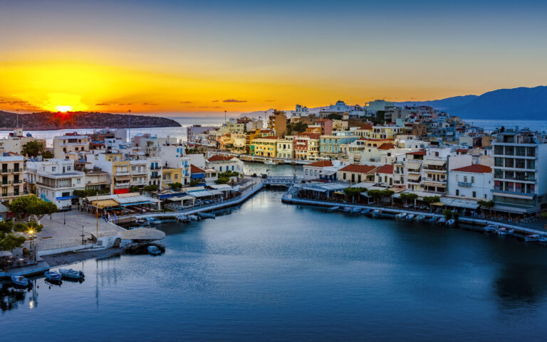 Agios Nikolaos. Agios Nikolaos is a picturesque town in the eastern part of the island Crete built on northwest side of the peaceful bay of Mirabello. Lake Vouliagmeni, Agios Nikolaos, Crete, Greece