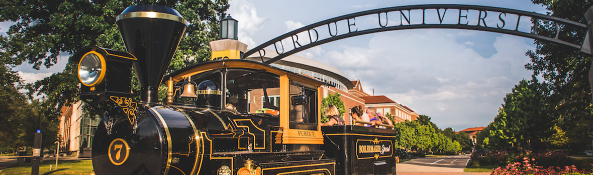 The Boilermaker Special passes through the Gateway to the Future arch on the campus of Purdue University