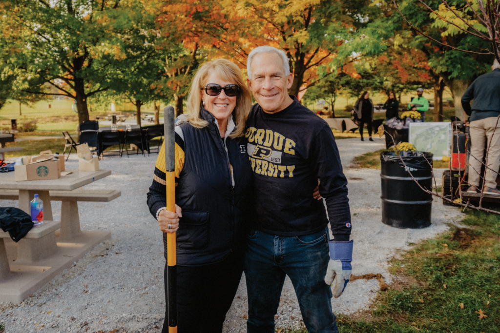 Martin and Jan Pickett standing with their arms wrapped around each other