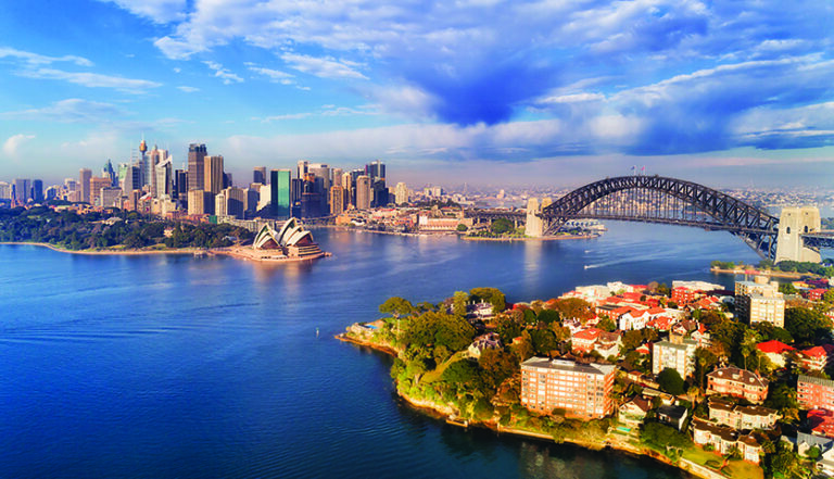 Quiet still earlier morning gentle sun light over Sydney city main landmarks around Harbour waters and shores between CBD and lowe North Shore.