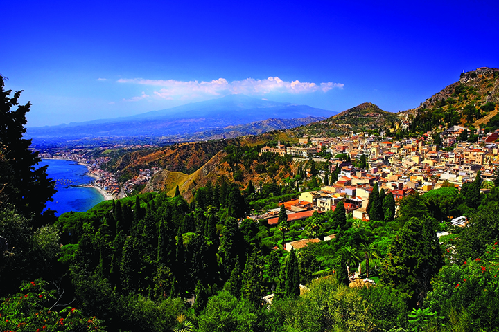 Traditional Sicilian village Taormina with view on Etna vulcano.