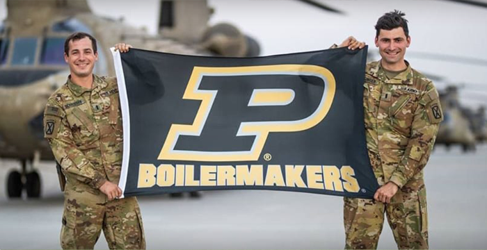 Image featuring two members of the Purdue Army ROTC Alumni Network holding Purdue's flag.