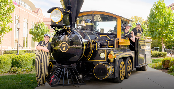 Image featuring Purdue Reamer students posing in front of a train.