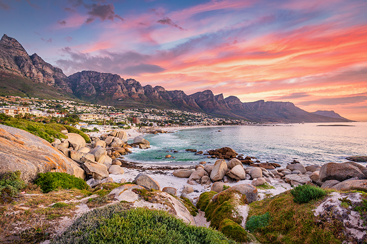 Beautiful sunset twilight view to Camps Bay, Scenic view during colorful sunset with beautiful cloudscape. Camps Bay the famous suburb of the city of Cape Town with white sandy beaches underneath the Table Mountain. Camps Bay, Cape Town, South Africa, Africa.