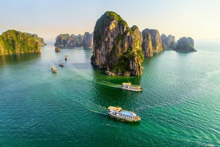 Aerial view floating fishing village and rock island, Halong Bay, Vietnam, Southeast Asia. UNESCO World Heritage Site. Junk boat cruise to Ha Long Bay. Popular landmark, famous destination of Vietnam