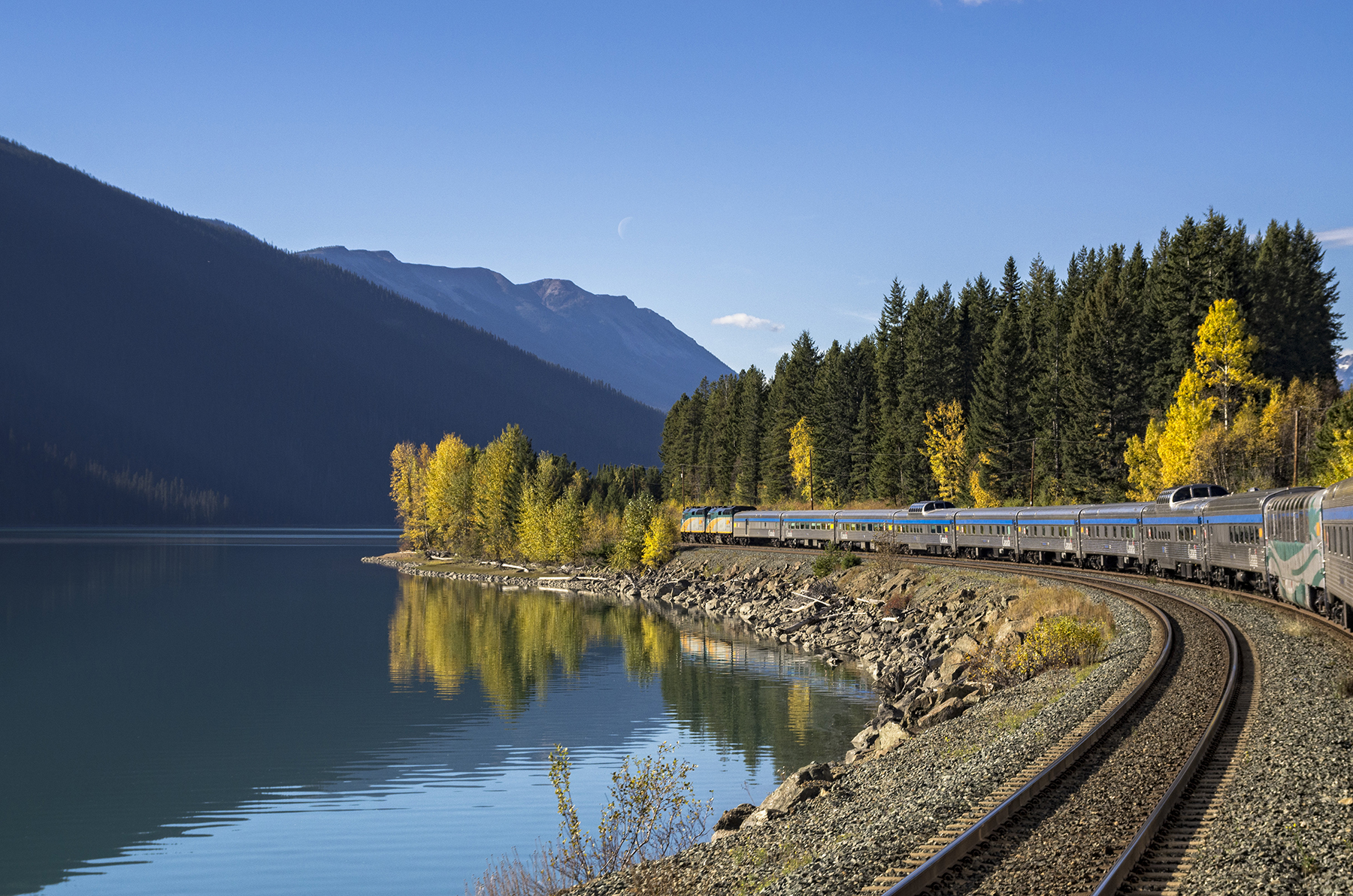 Passenger train along Moose Lake in Jasper National Park, Alberta, Canada.