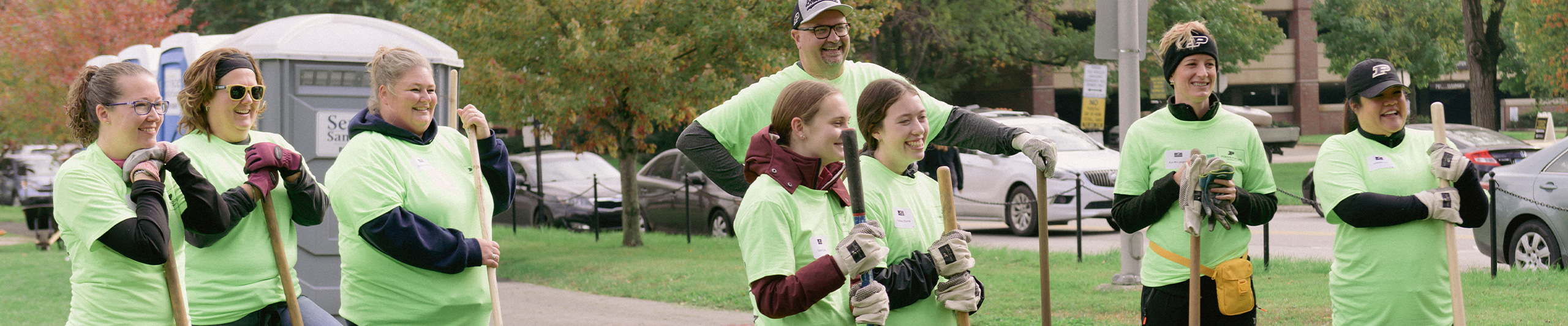 Volunteers holding shovel's during a break time