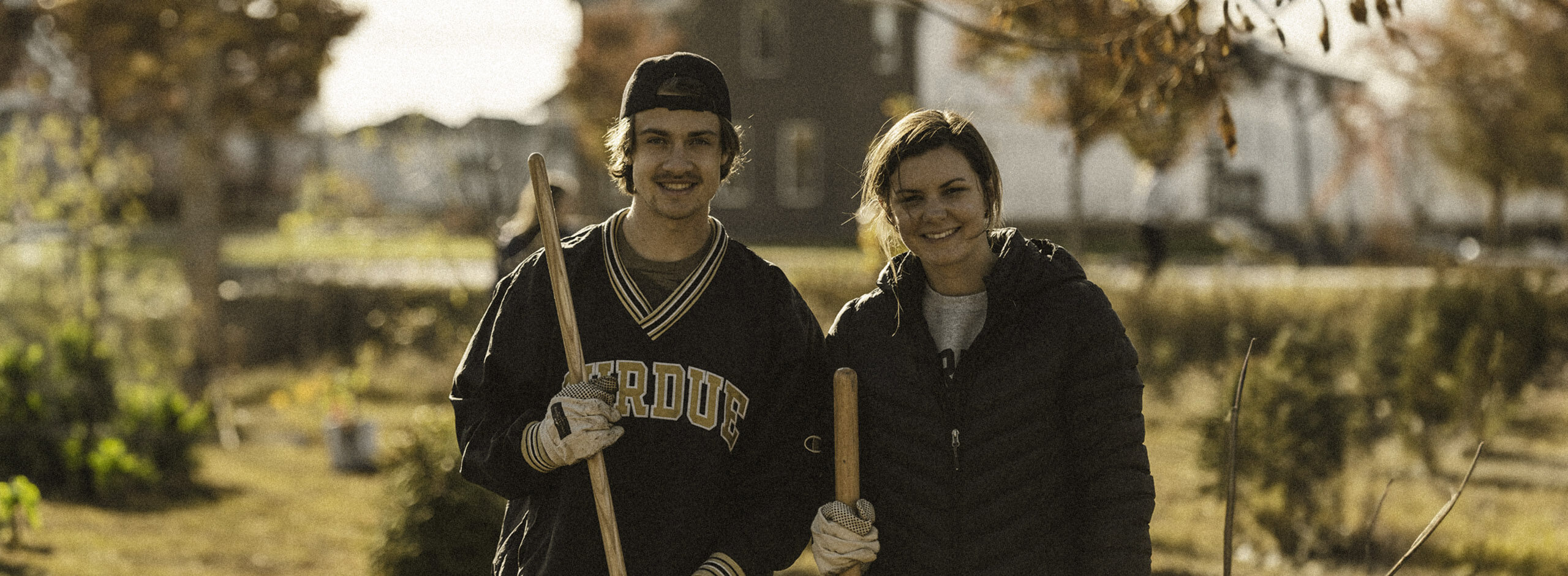 Two students planting trees at Purdue University