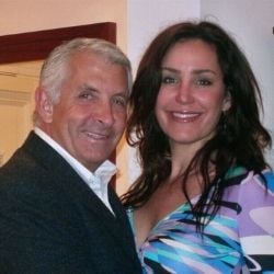 A man and a woman standing next to each other smiling