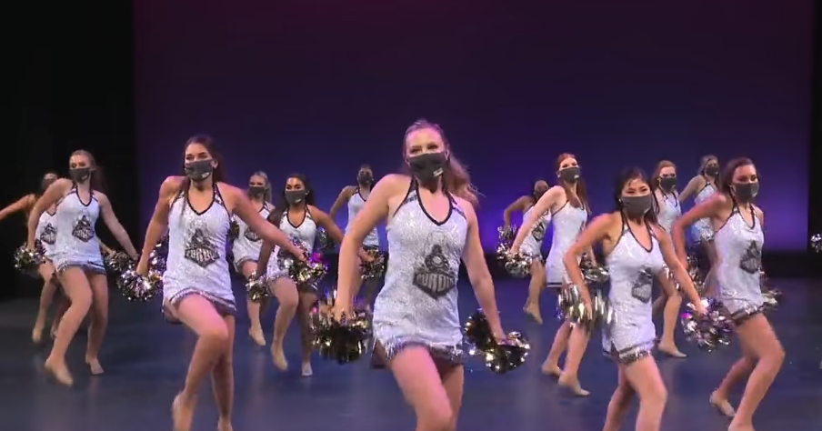 Purdue University's Cheer team performing on a stage