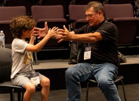 A child interacting with their grandparents at a GPU event