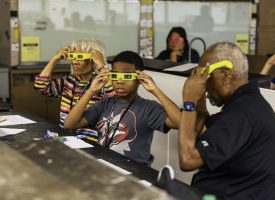 Two grandparents and their grandchild at a GPU activity