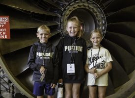 3 Kids standing in front of a turbine at a GPU event