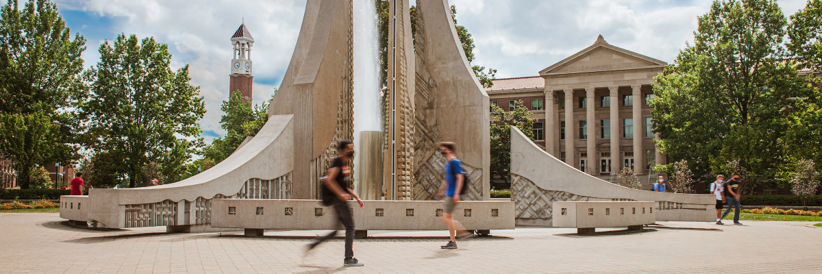 Students walking past the engineering fountain during the day