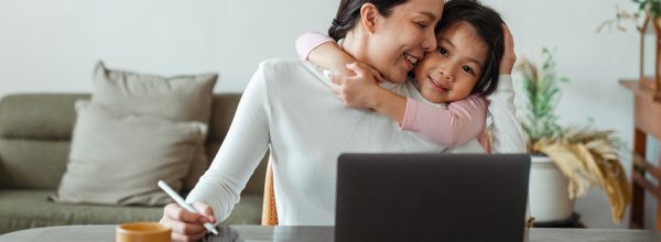 Child hugging woman from behind