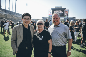 President Mung Chiang; Arnette Tiller, wife of Joe Tiller; and Purdue athletic director Mike Bobinski.