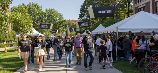 Crowds of people attending Purdue University’s Homecoming campus events.