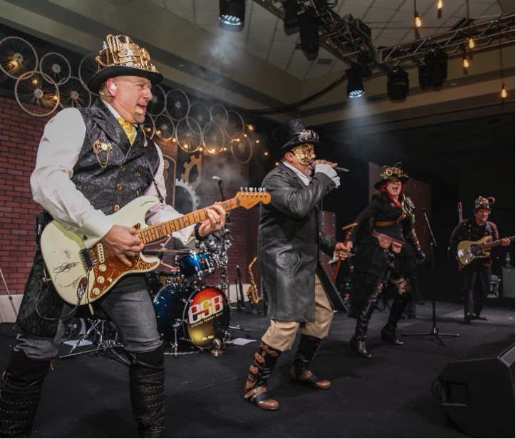 2 men playing guitar in steampunk outfits