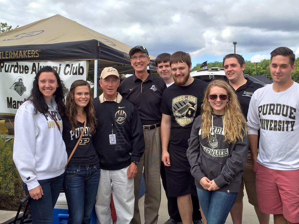 A group of Purdue Alumni posing for a photo with Mitch Daniels
