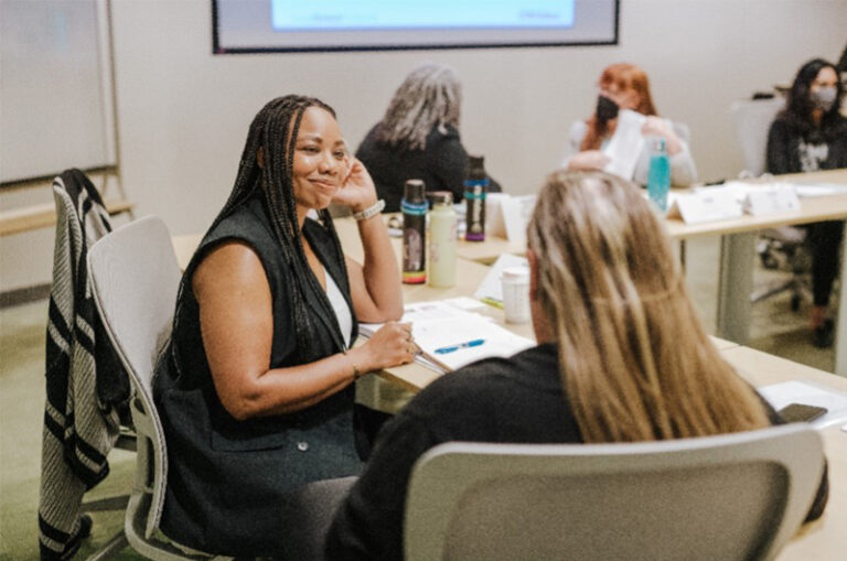 An image showing two women engaged in a conversation.