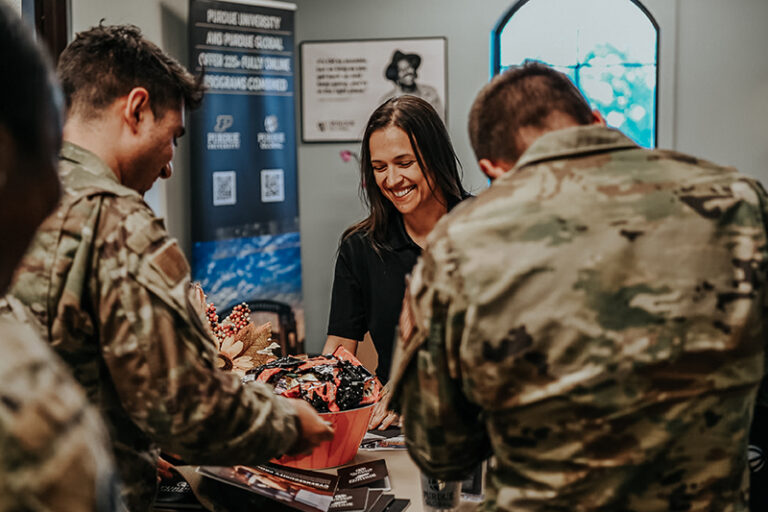 Sonora Vasquez, a Purdue Global representative, hands out pamphlets and shares information about the school during an education center open house at Vandenberg Space Force Base.