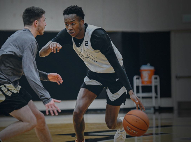 2 Purdue University's men basketball players practicing against each other