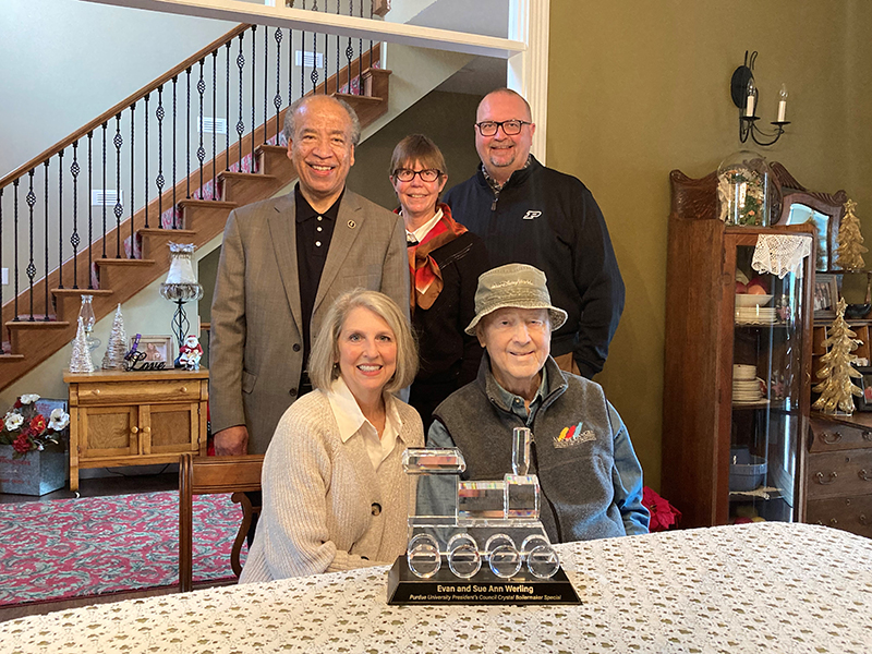 Sue Ann and Evan Werling (seated) received a Purdue President’s Council award, the Crystal Boilermaker Special Train, on Dec. 11 in recognition of their lifetime of loyalty, commitment and generosity. Pictured standing (from left) are Willie Reed, dean of the College of Veterinary Medicine; Deborah Knapp, Distinguished Professor of Comparative Oncology; and Matt Folk, president and CEO of the Purdue for Life Foundation.