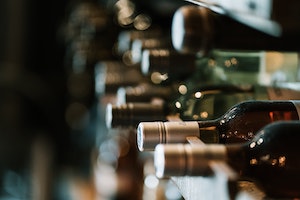 Wine bottles sitting on a shelf